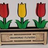 A wooden flower pot made with glowforge